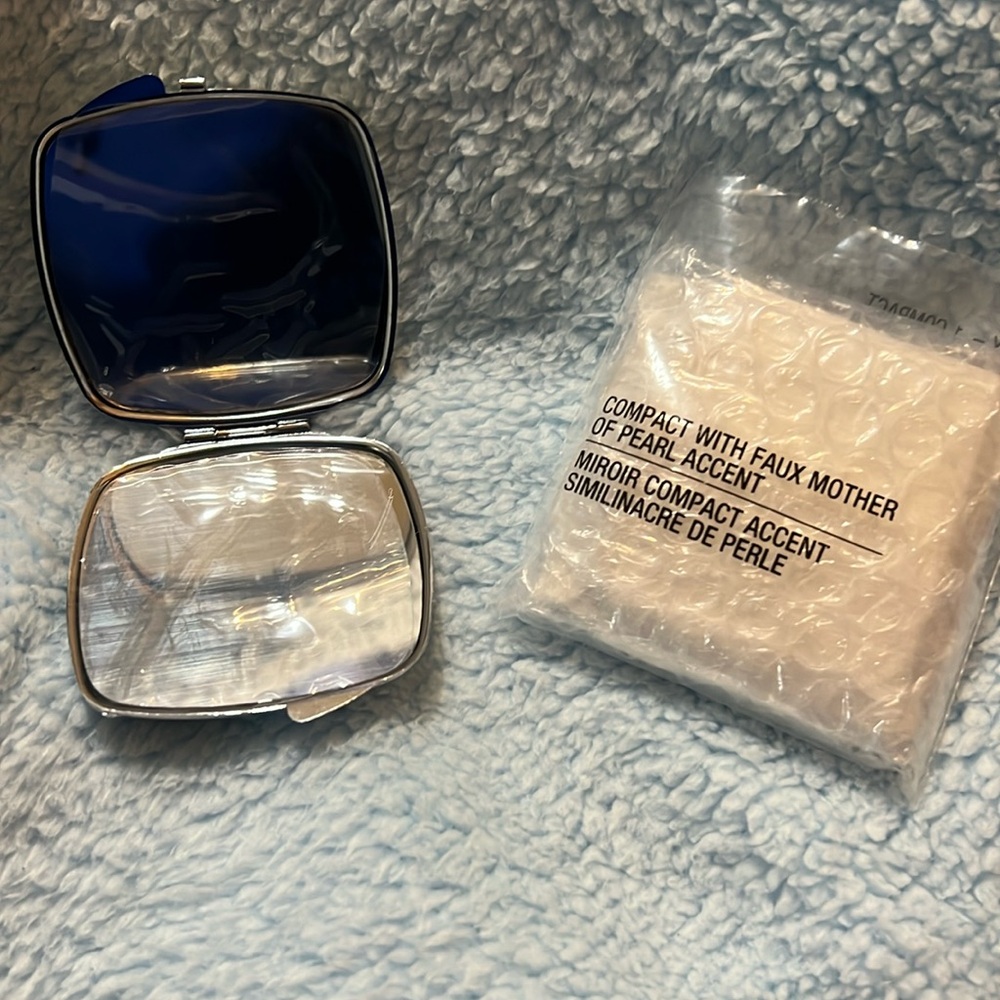 Brand new in Packaging Avon faux Mother of pearl accented compact mirror
